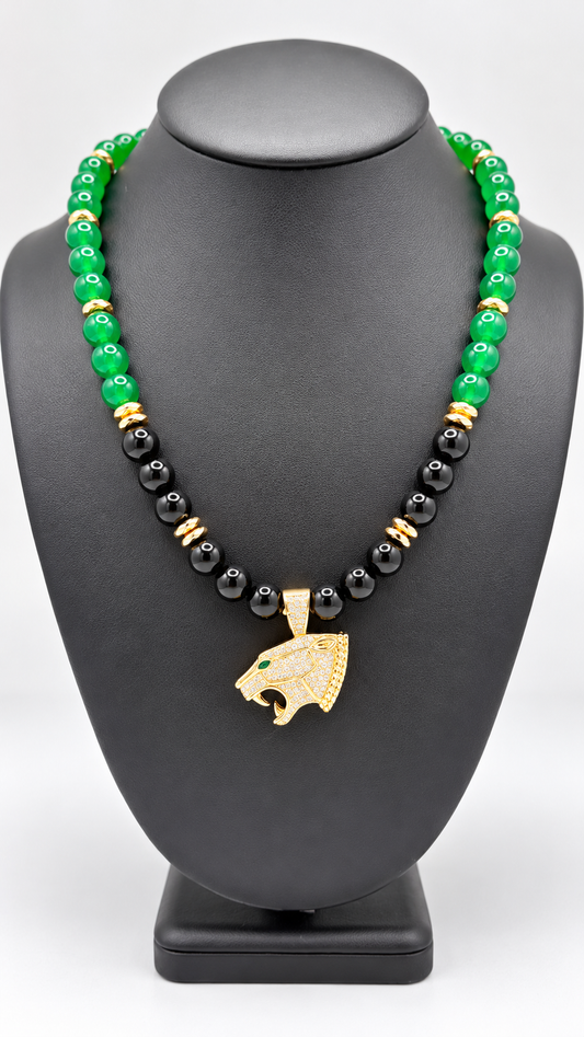 Green and black beaded necklace with gold-tone accents and a panther-head pendant on a black display bust
