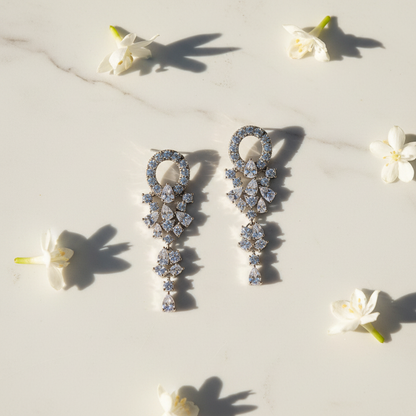Crystal Cascade Earrings flat lay on marble with flowers